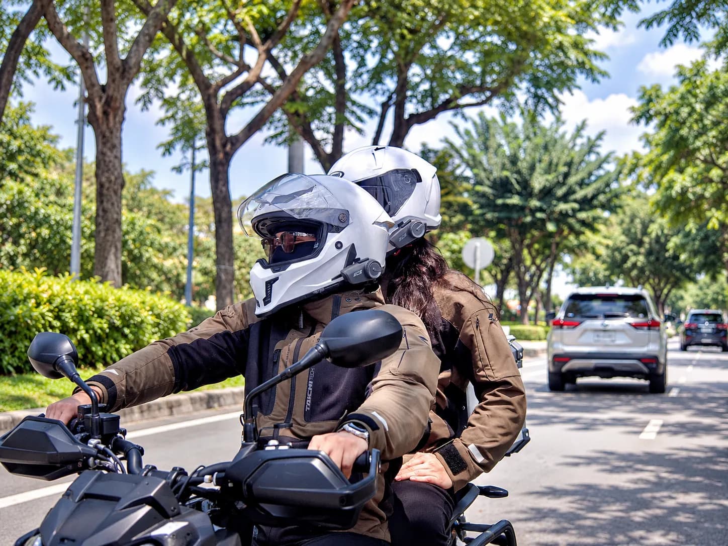 A couple wearing helmets fitted with the units, stopped before setting off.